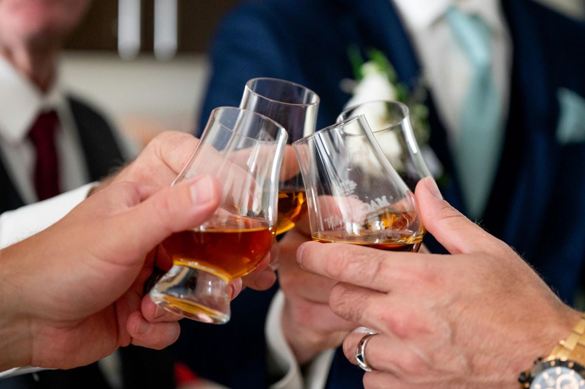 Men toasting with glasses of bourbon